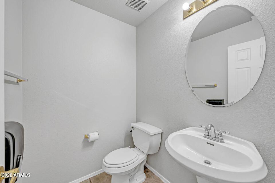 6410 West Hackamore Drive Phoenix, AZ 85083 - Photo 30 of 50 a bathroom with a toilet sink and mirror