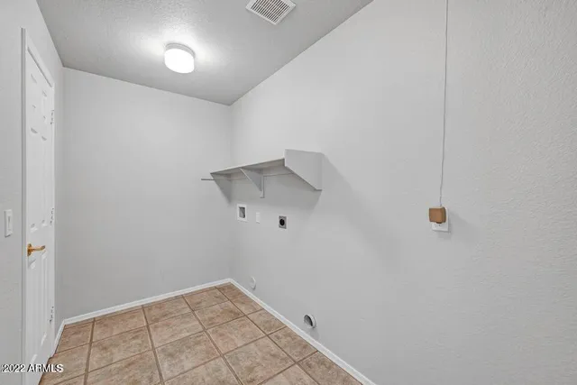 a view of empty room with wooden floor and windows