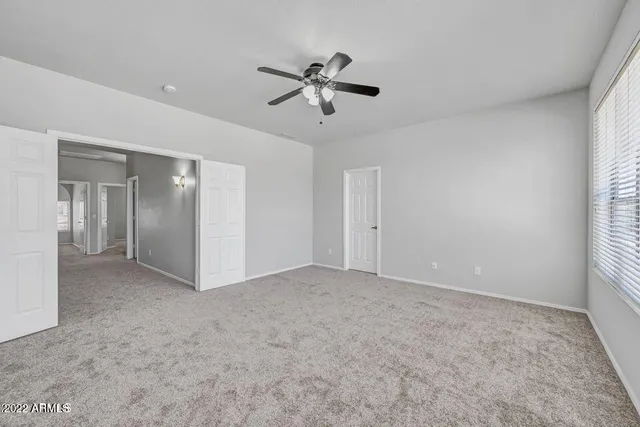 a view of empty room with ceiling fan
