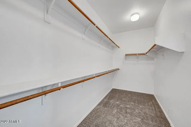 an empty room with a window and a ceiling fan