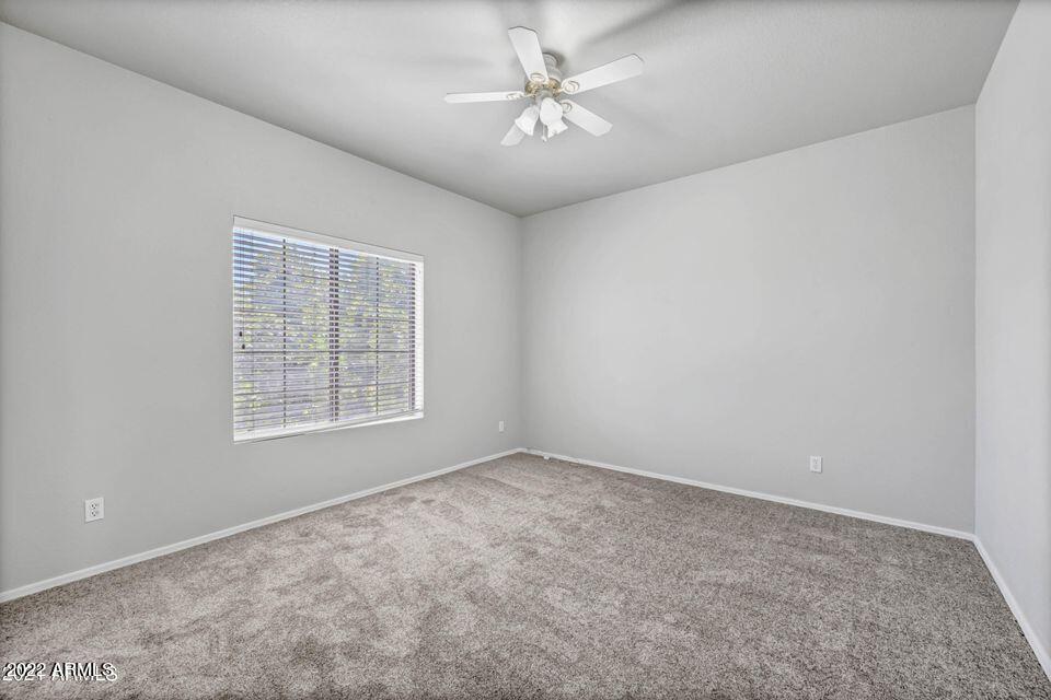6410 West Hackamore Drive Phoenix, AZ 85083 - Photo 39 of 50 an empty room with windows and fan