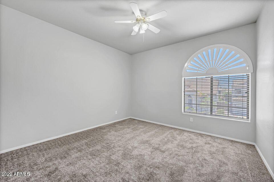 6410 West Hackamore Drive Phoenix, AZ 85083 - Photo 40 of 50 an empty room with windows and fan