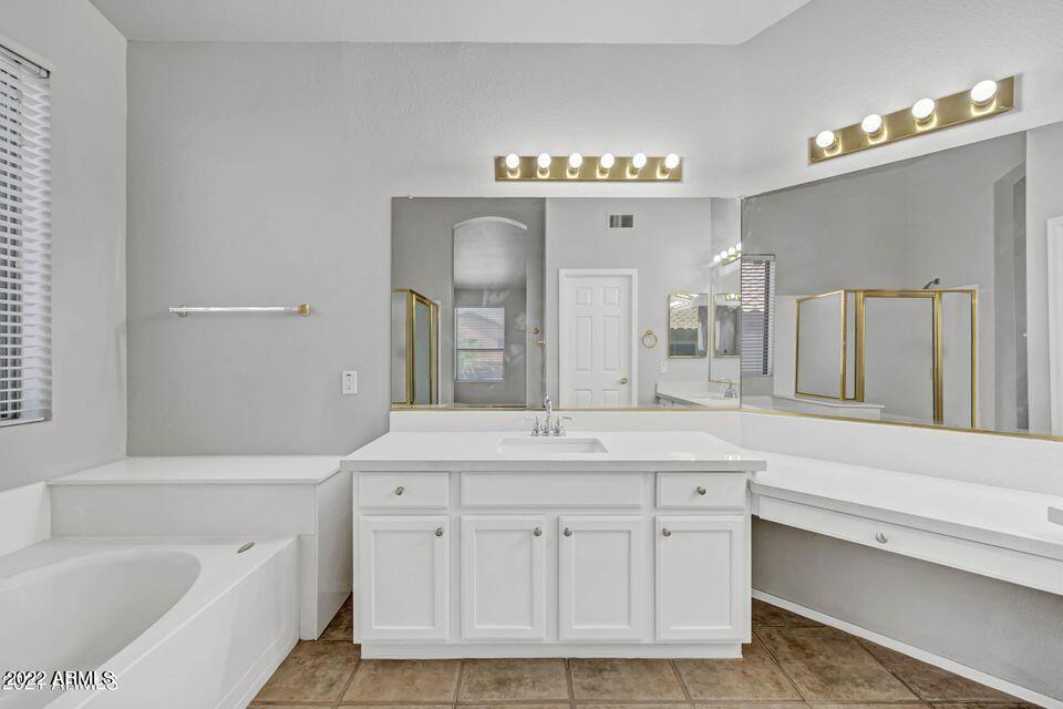 6410 West Hackamore Drive Phoenix, AZ 85083 - Photo 49 of 50 a bathroom with a sink double vanity granite tub shower and a mirror