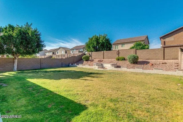 a view of an empty room with window and bathroom