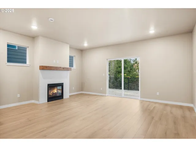 a view of kitchen and hall with wooden floor