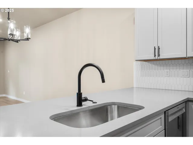 a open kitchen with kitchen island a sink stainless steel appliances and cabinets