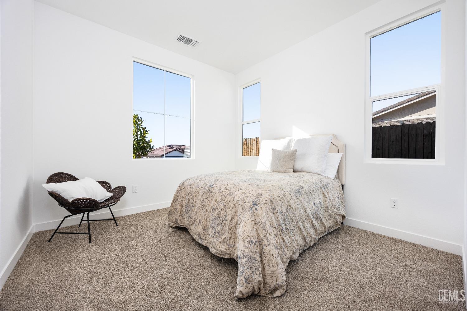 Undisclosed Address Bakersfield, CA 93314 - Photo 17 of 36 a bed room with a bed and a chair