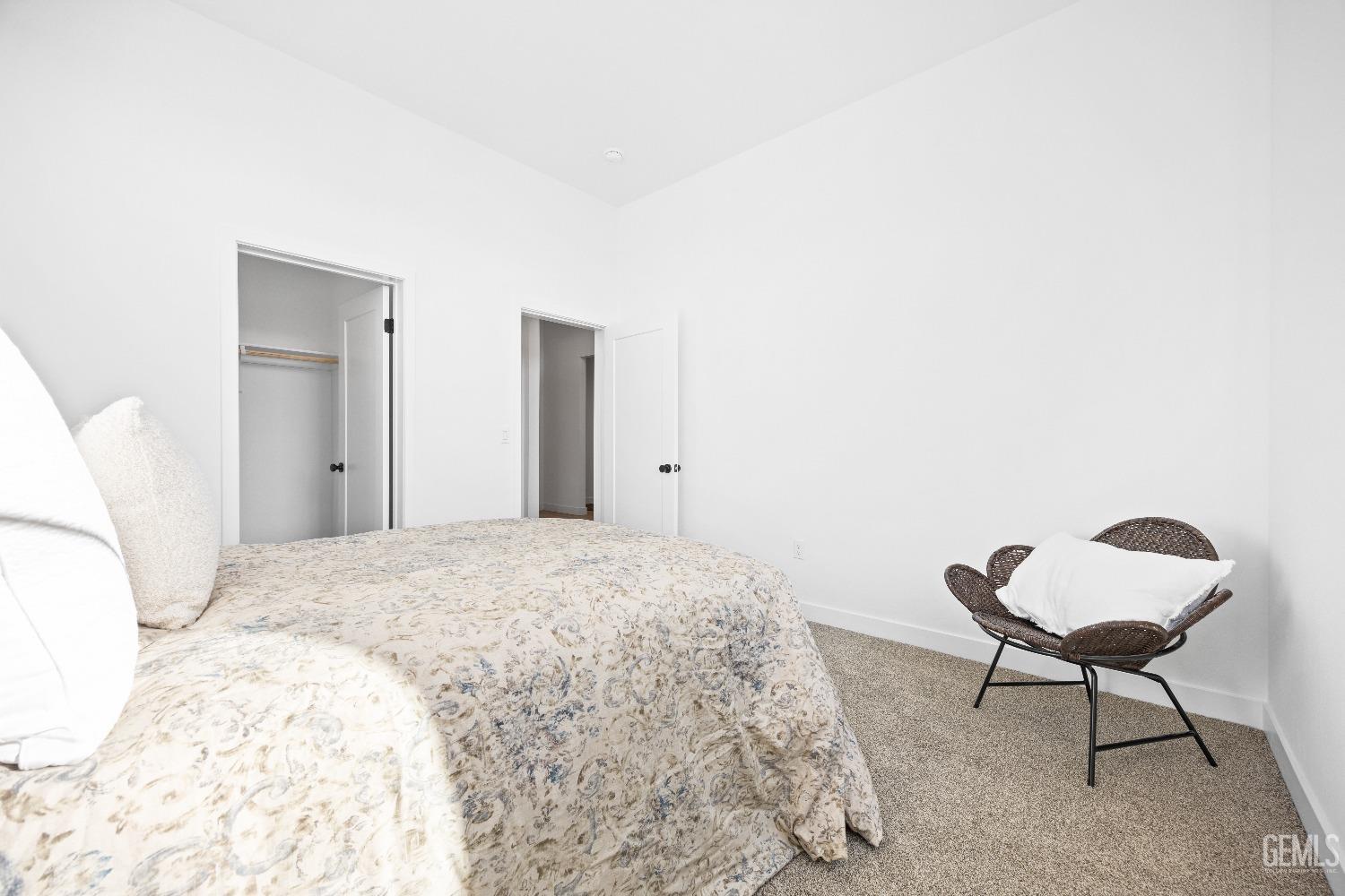 Undisclosed Address Bakersfield, CA 93314 - Photo 18 of 36 a spacious bedroom with a bed and chair