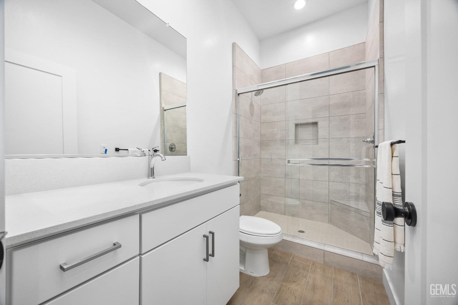 Undisclosed Address Bakersfield, CA 93314 - Photo 19 of 36 a bathroom with a shower sink vanity mirror and toilet