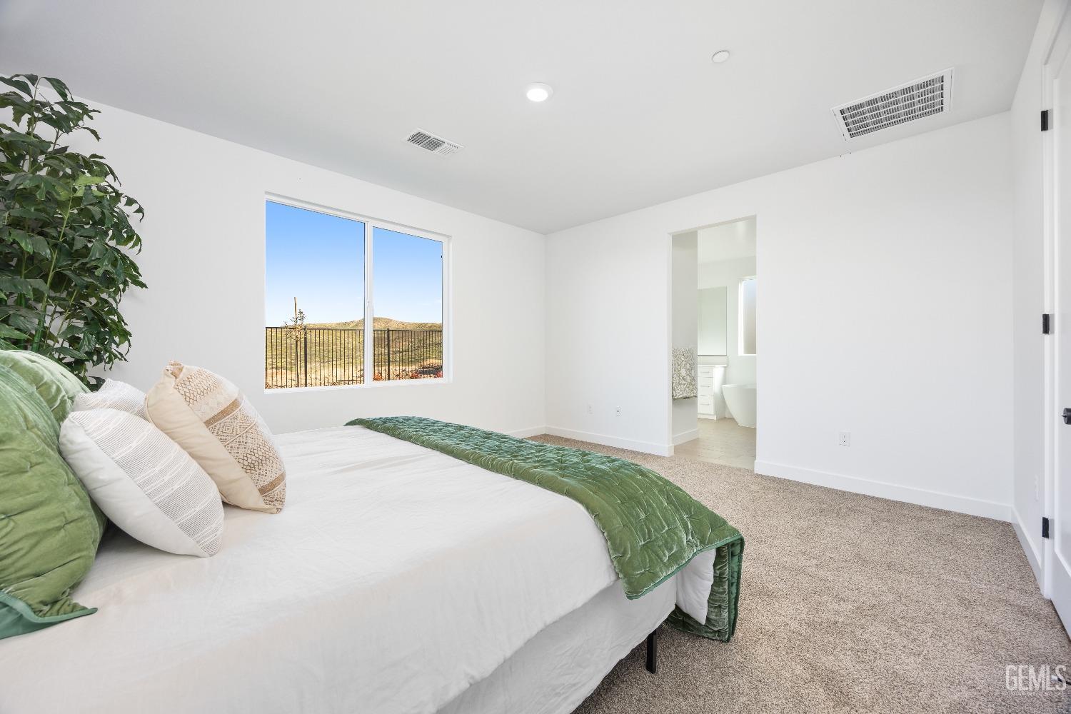 Undisclosed Address Bakersfield, CA 93314 - Photo 3 of 36 a bedroom with a bed and a potted plant