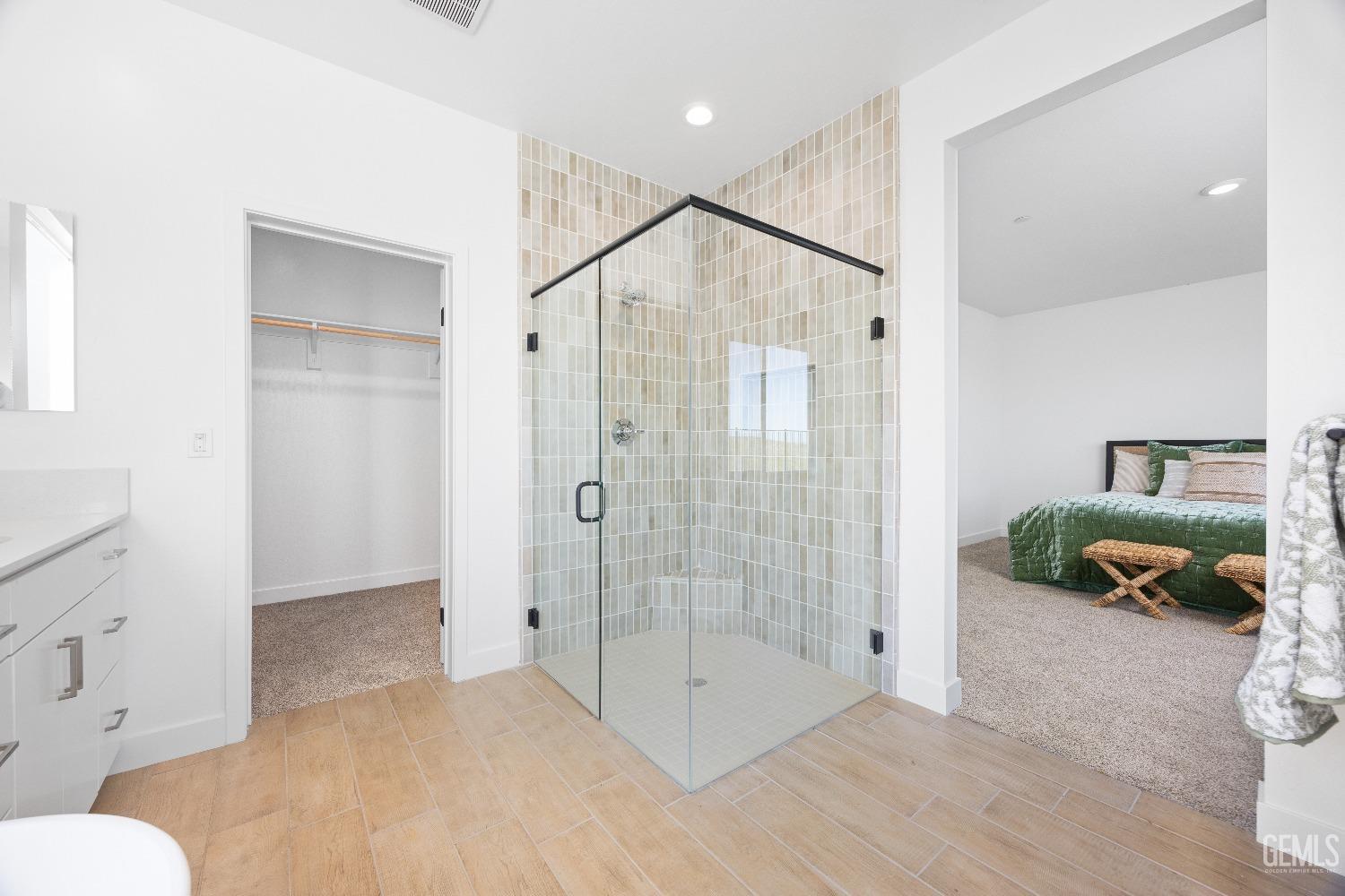 Undisclosed Address Bakersfield, CA 93314 - Photo 6 of 36 a spacious bathroom with a glass shower door