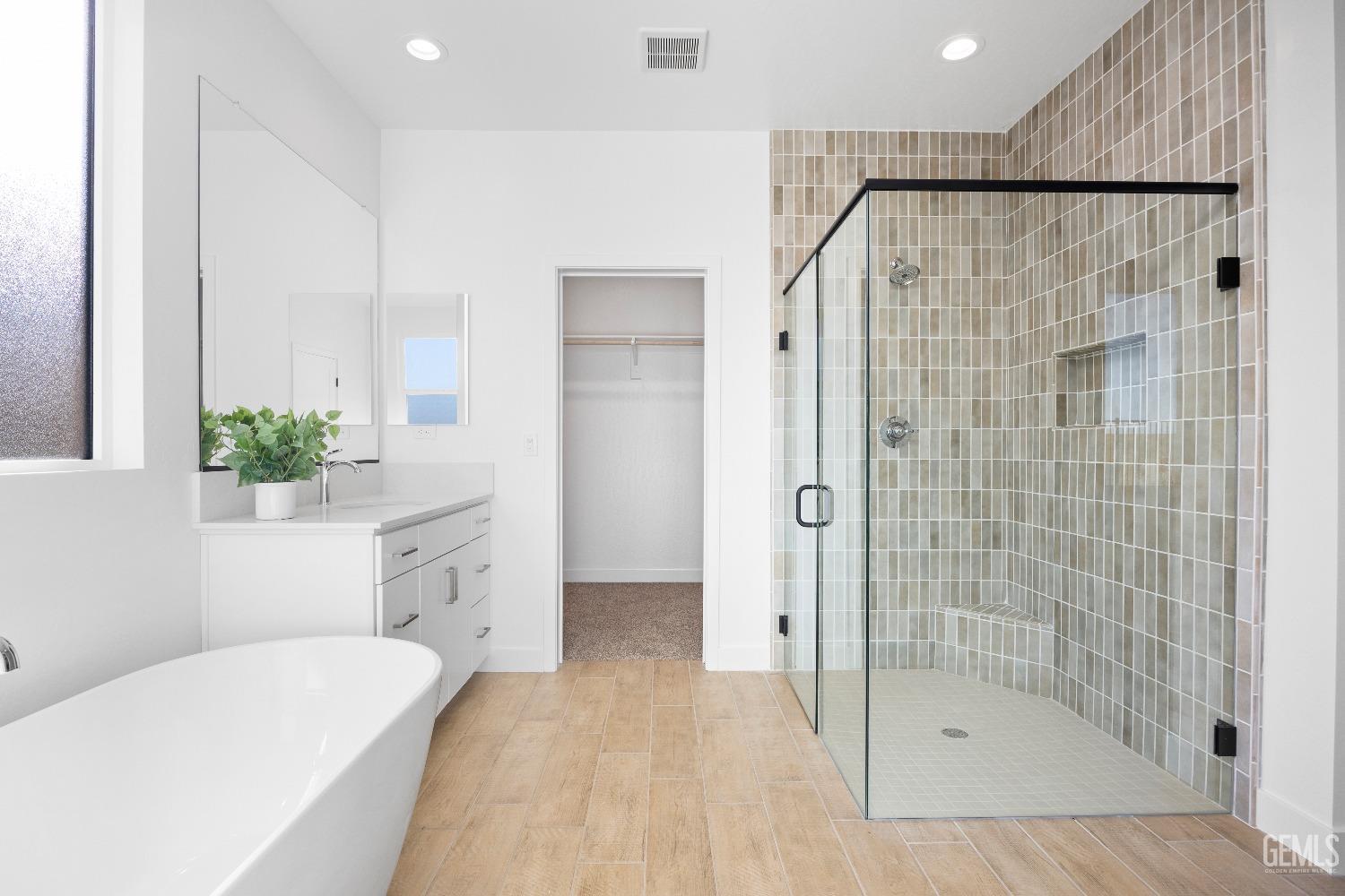 Undisclosed Address Bakersfield, CA 93314 - Photo 7 of 36 a bathroom with a bathtub and a shower