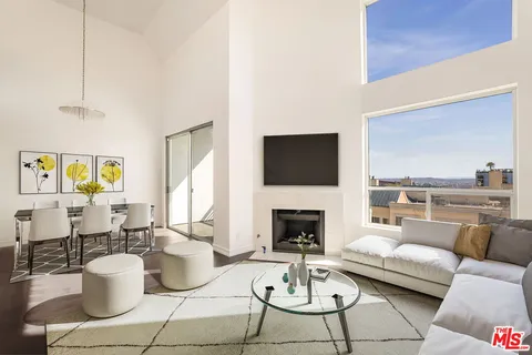 a living room with furniture a rug and a fireplace
