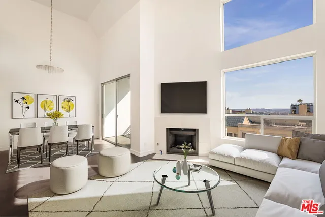 a living room with furniture a rug and a fireplace