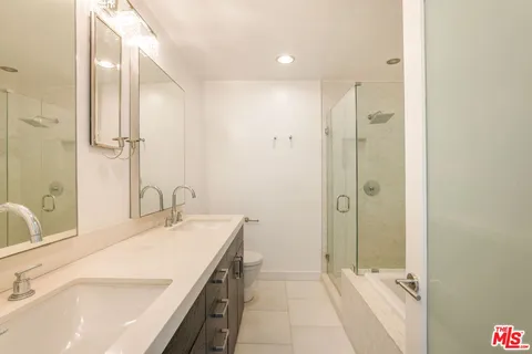 a bathroom with a tub sink and mirror
