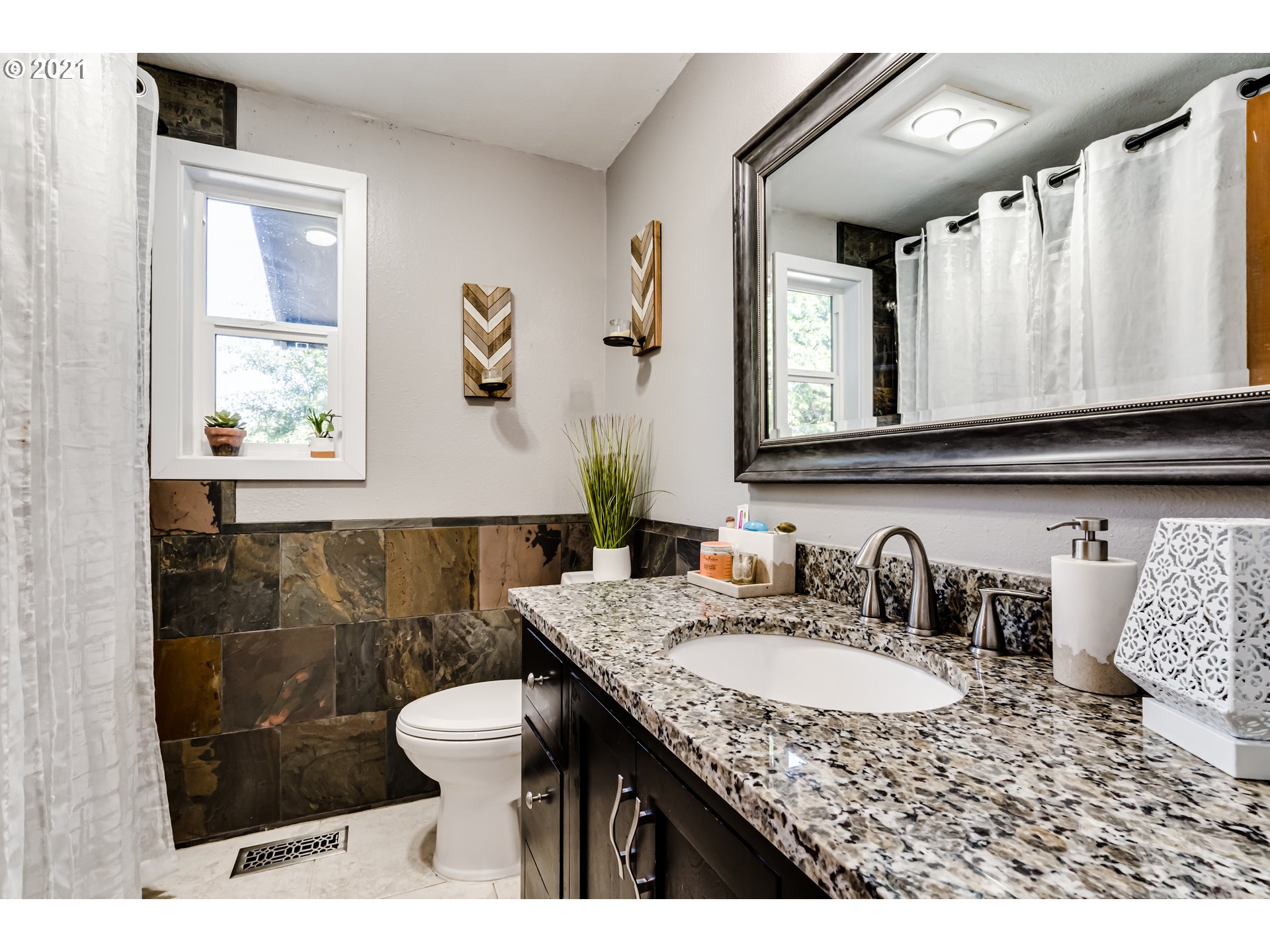 32945 Dillard Road Eugene, OR 97405 - Photo 24 of 30 a bathroom with a granite countertop sink a toilet a mirror and shower