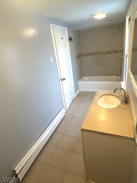 82 Pacific Street Newark, NJ 07105 - Photo 8 of 9 a bathroom with a sink and a mirror