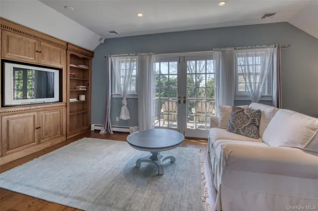 a living room with furniture a window and a floor to ceiling window