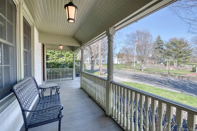 a view of two chairs in the balcony