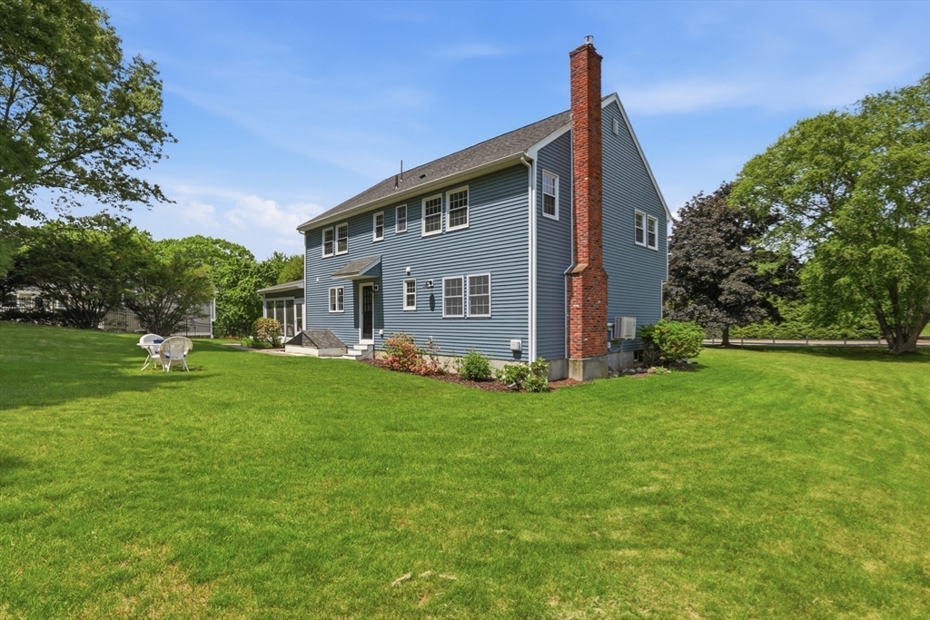 94 Johnson Road Winchester, MA 01890 - Photo 35 of 40 a view of a house with a backyard