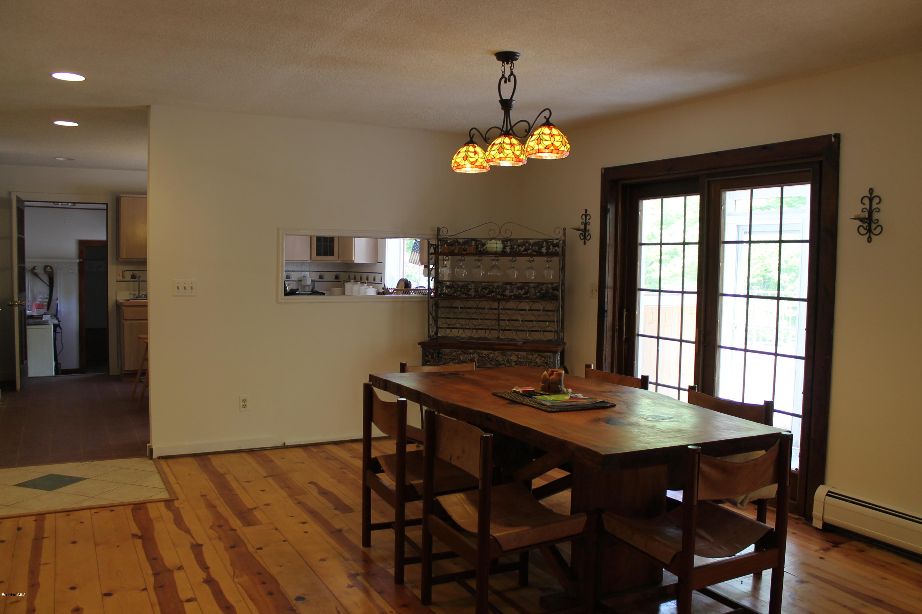 522 Leonhardt Road Becket, MA 01223 - Photo 14 of 23 a view of a dining room with furniture a chandelier and wooden floor