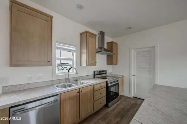 a kitchen with a sink cabinets and a window