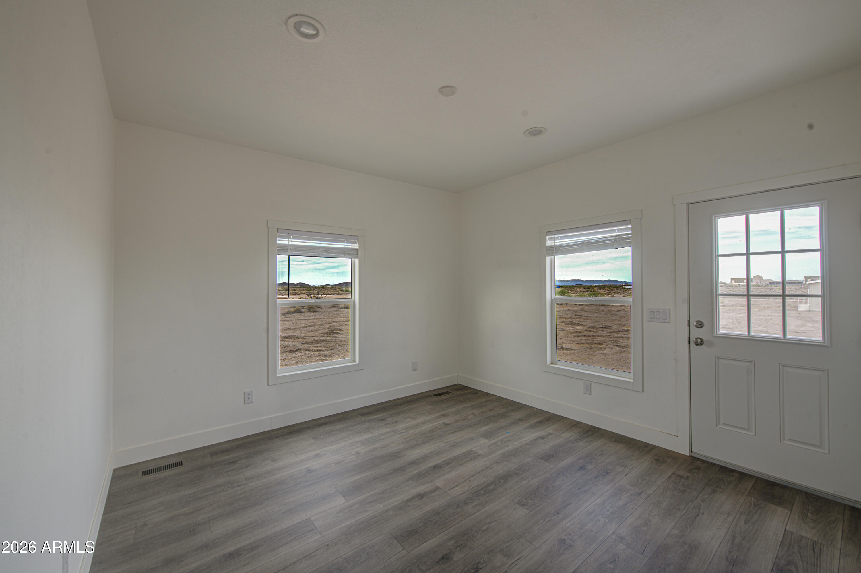 39120 West Maldonado Road Tonopah, AZ 85354 - Photo 17 of 37 an empty room with wooden floor and windows