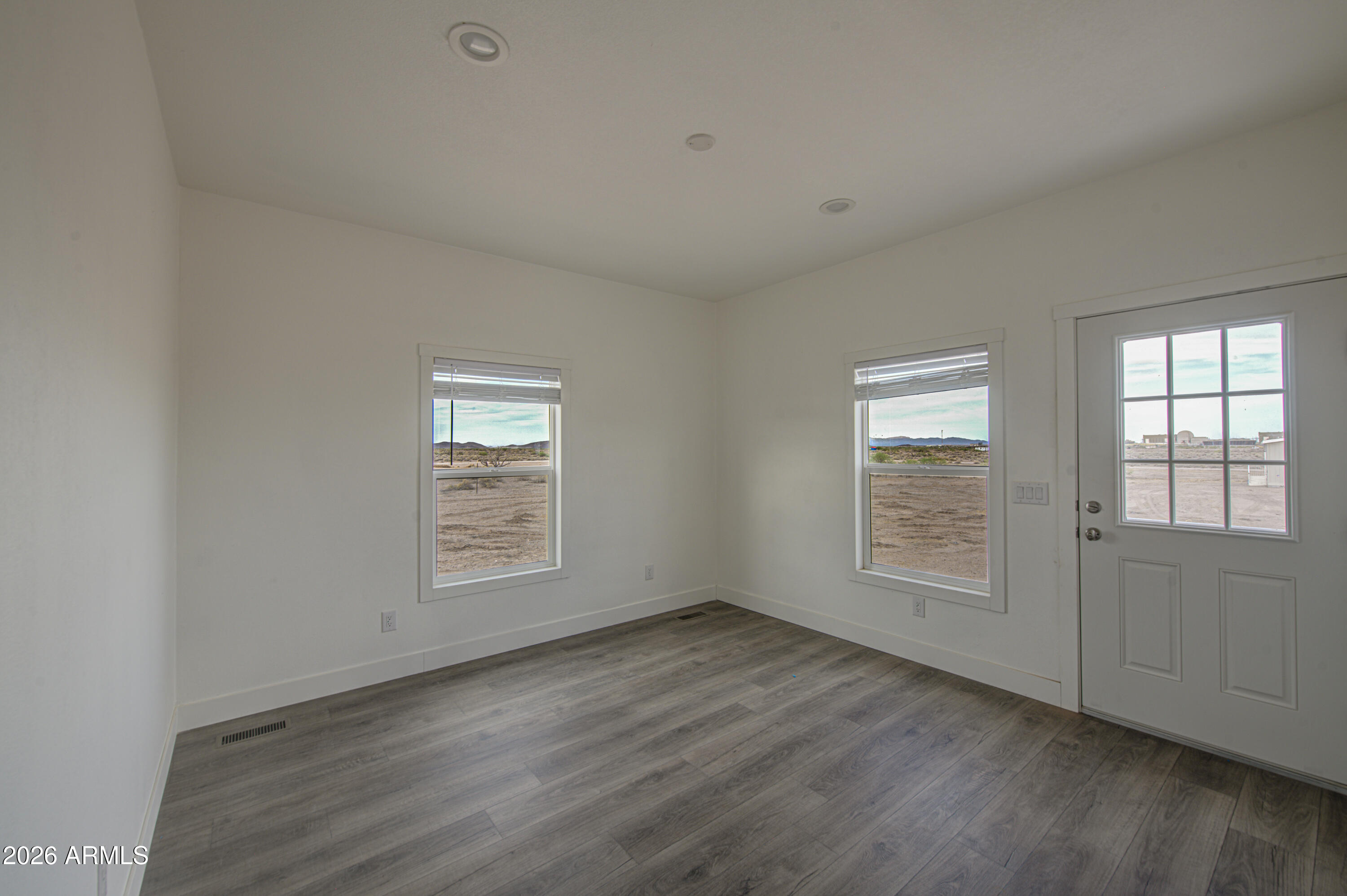 39120 West Maldonado Road Tonopah, AZ 85354 - Photo 18 of 37 an empty room with wooden floor and windows