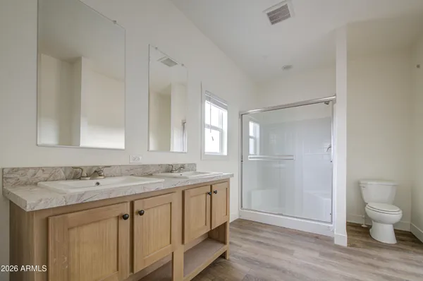 a bathroom with a granite countertop sink a toilet and a mirror