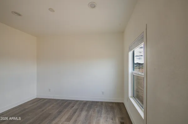 a view of an empty room and wooden floor