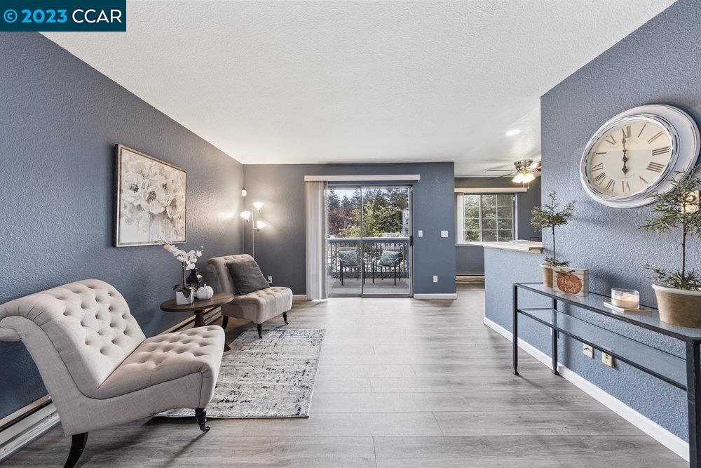a living room with furniture a clock and a window