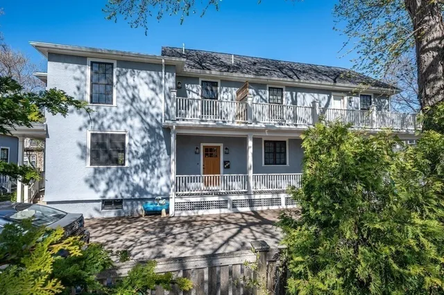 a front view of a house with plants