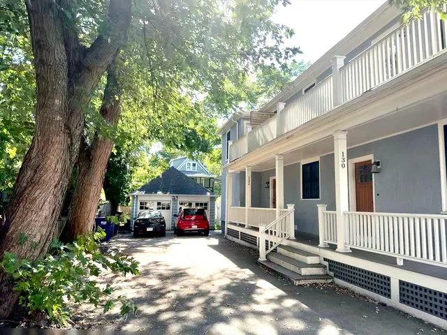 a view of a house with a bench in a patio
