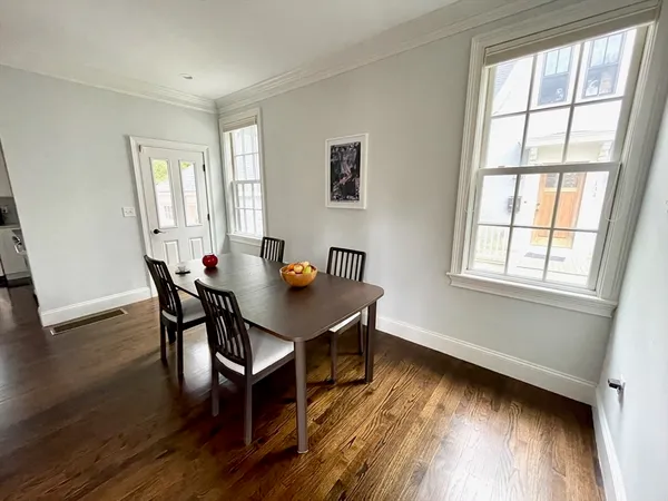 a view of a dining room with furniture and wooden floor