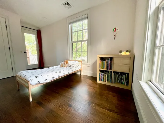 a living room with a bed furniture and a window