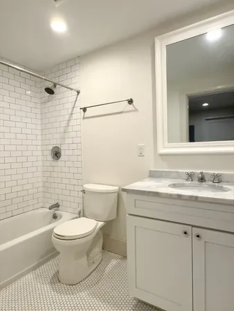 a bathroom with a sink a toilet and a bathtub