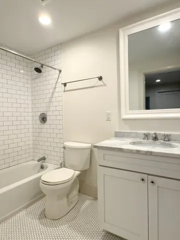 a bathroom with a sink a toilet and a bathtub