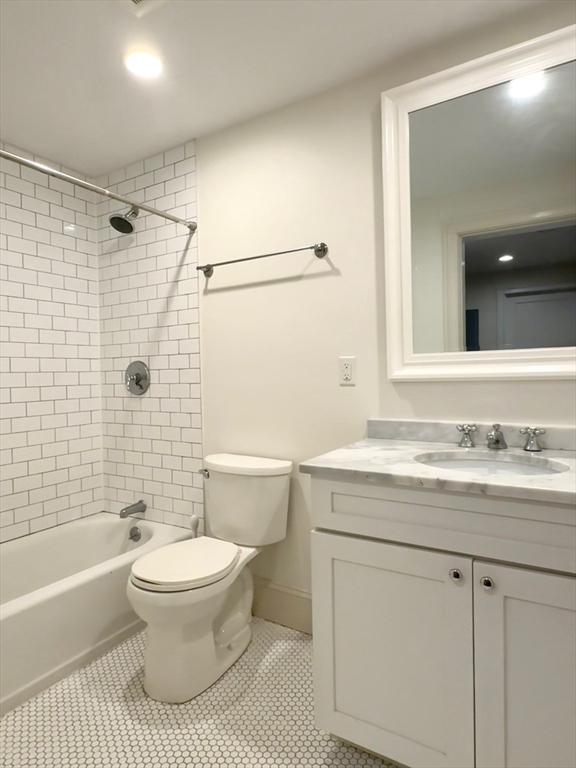 132 Rindge Avenue, Unit 1 Cambridge, MA 02140 - Photo 8 of 11 a bathroom with a sink a toilet and a bathtub