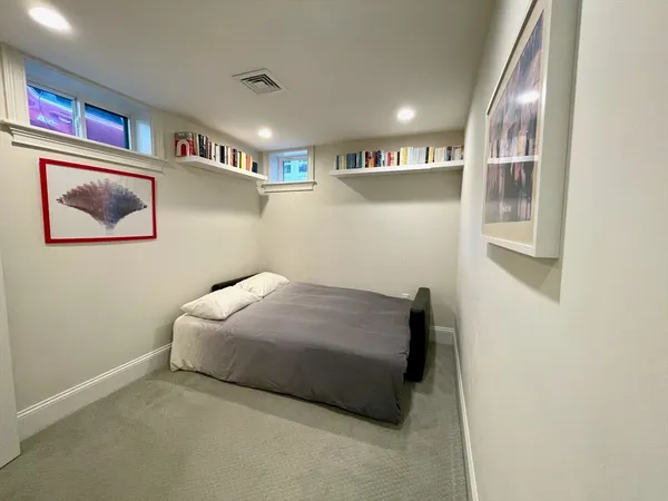 a bedroom with a bed and wall painting