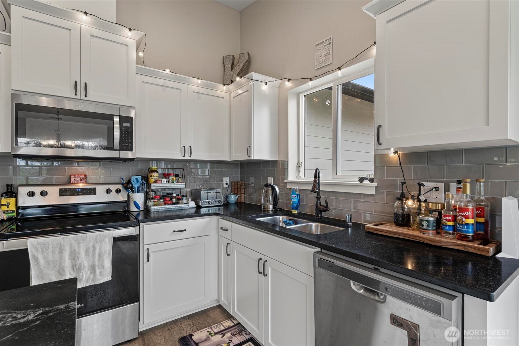 144-38 18 Loop Road Centralia, WA 98531 - Photo 13 of 39 a kitchen with stainless steel appliances granite countertop a sink stove and microwave