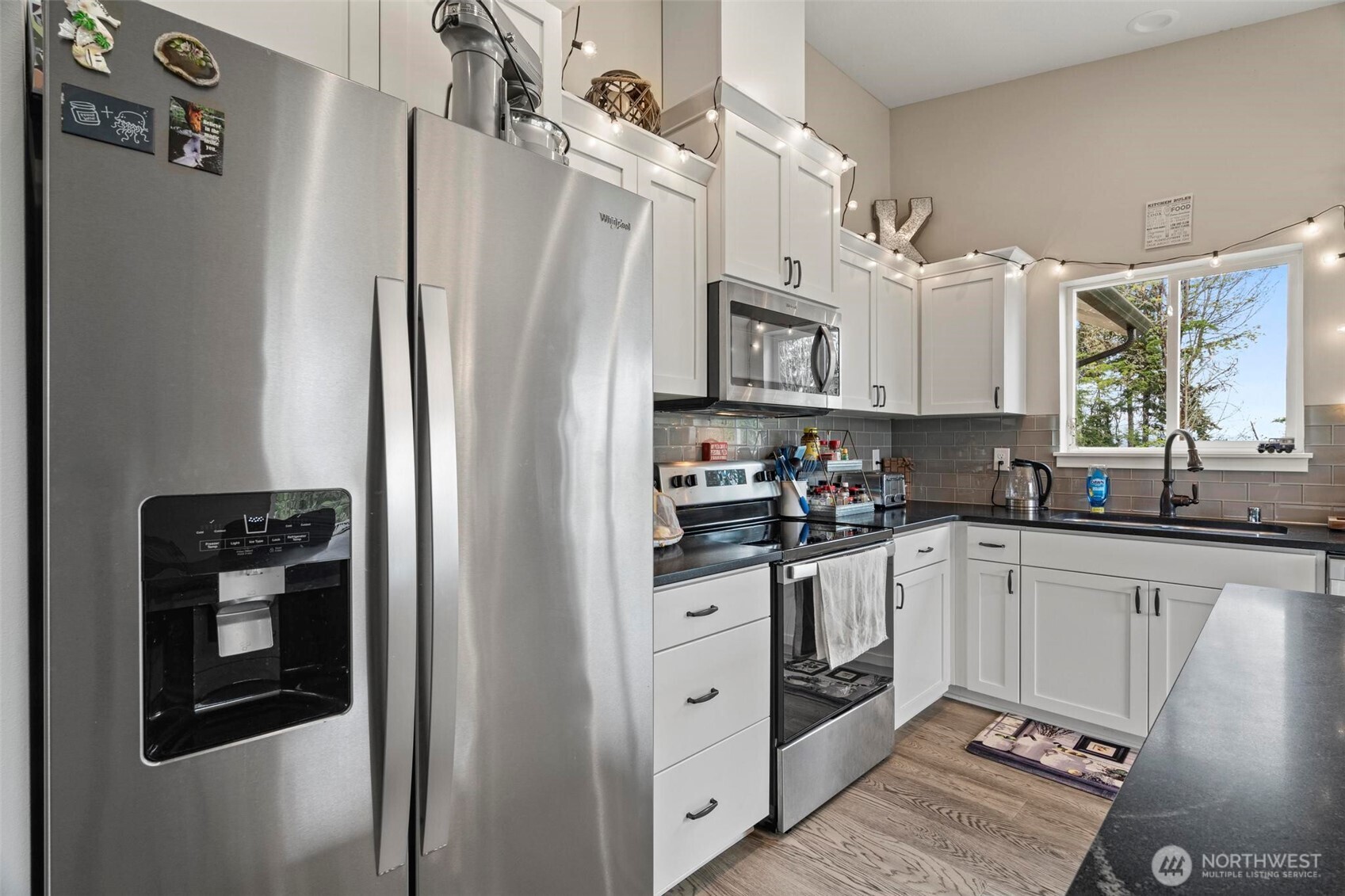 144-38 18 Loop Road Centralia, WA 98531 - Photo 15 of 39 a kitchen with stainless steel appliances a refrigerator sink and cabinets