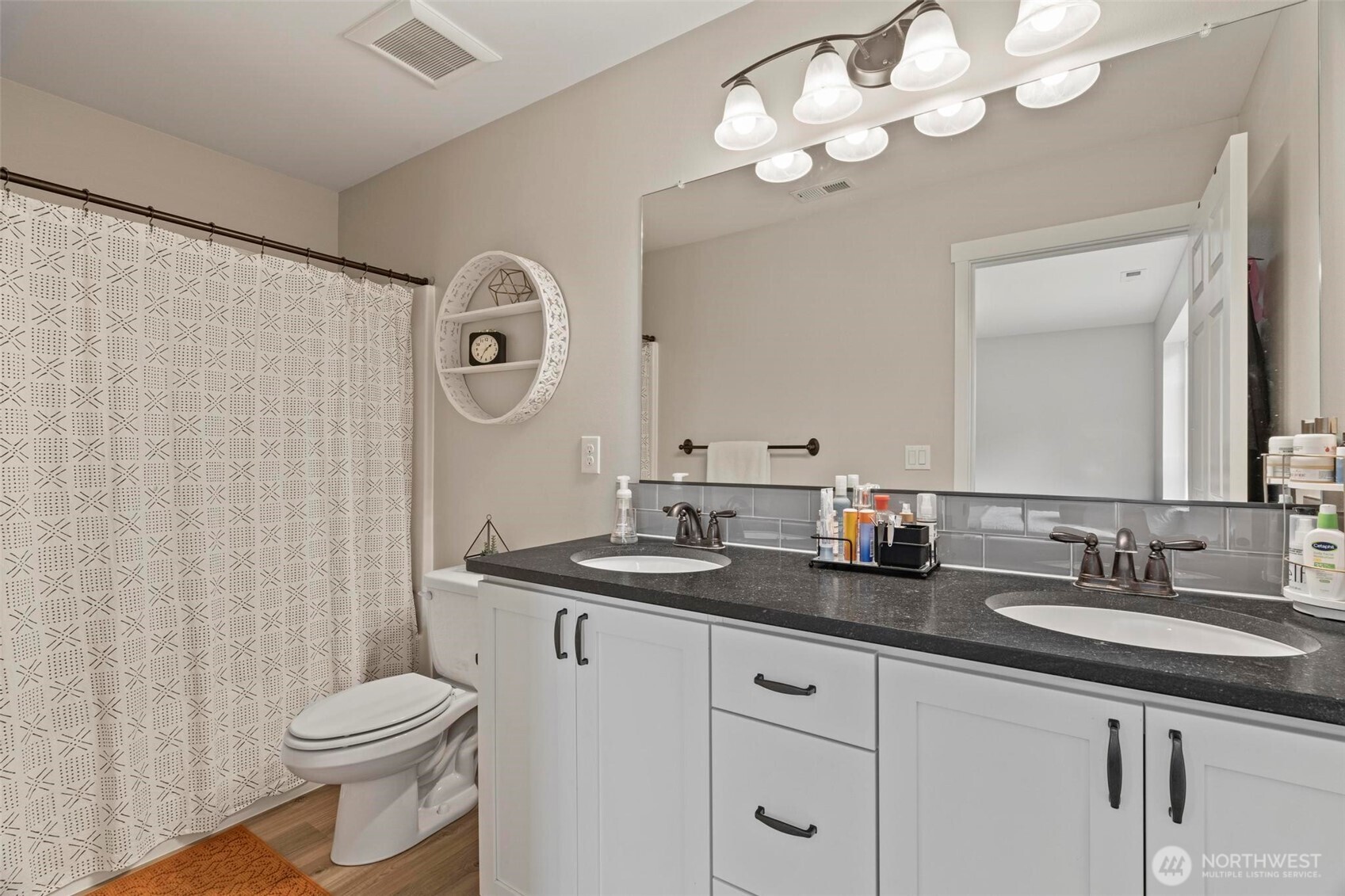 144-38 18 Loop Road Centralia, WA 98531 - Photo 25 of 39 a bathroom with a granite countertop sink a toilet and a mirror