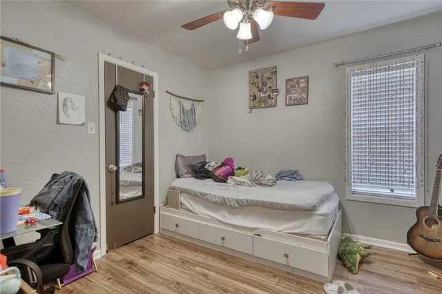 a bedroom with a bed and a chandelier