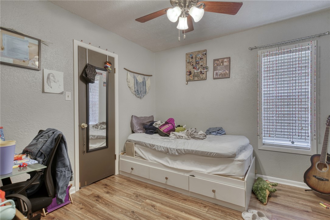 1410 Clement Court College Station, TX 77840 - Photo 10 of 16 a bedroom with a bed and a chandelier