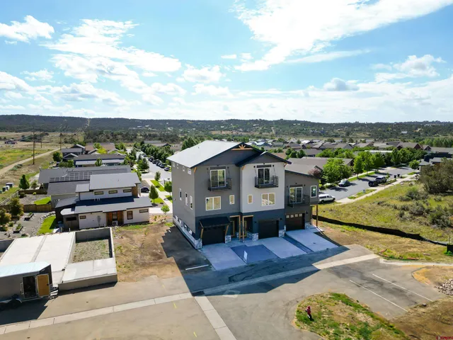 a kitchen with stainless steel appliances granite countertop a stove a sink dishwasher and a refrigerator with wooden floor
