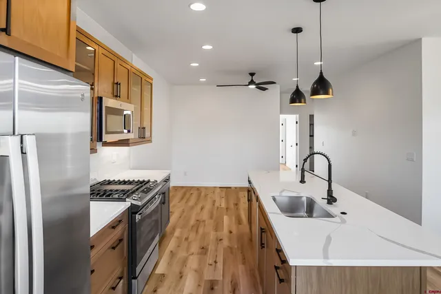 a view of a room with wooden floor windows and a ceiling fan