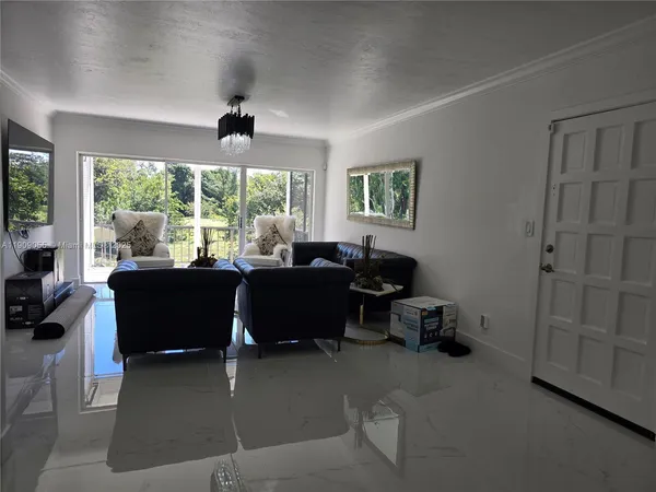 a living room with furniture and a large window