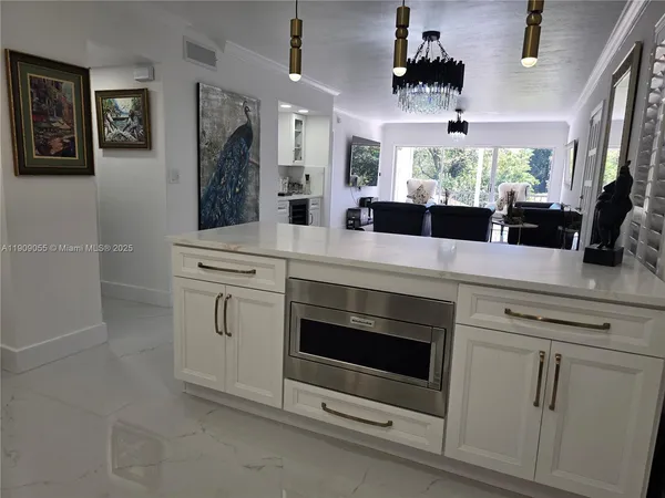 a kitchen with white cabinets and appliances