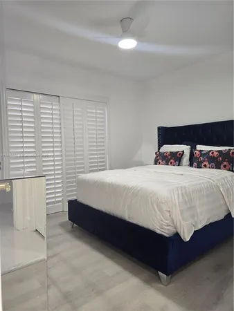 a bed sitting in a bedroom next to a window