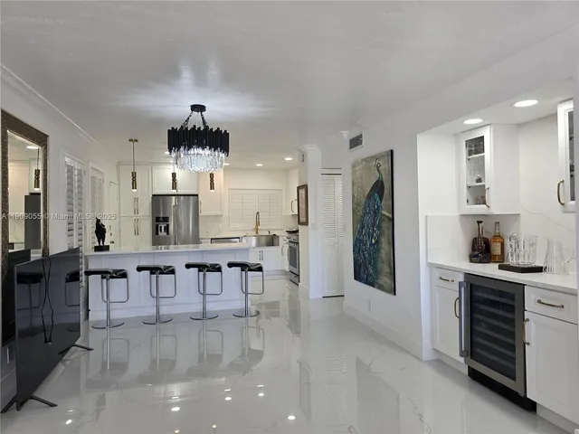 a living room with furniture or chandelier and a dining table